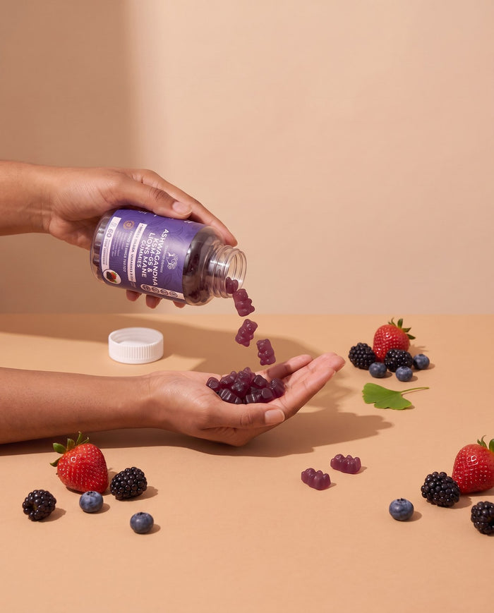 Mixed berries Ashwagandha gummies poured into a palm with berries on the table