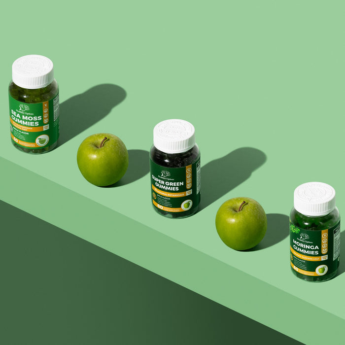 Healthier Options green gummies bottles in a row with fresh green apples